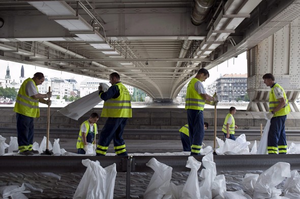 A Fővárosi Csatornázási Művek alkalmazottai gátat építenek homokzsákból Budapesten, az Erzsébet hídnál